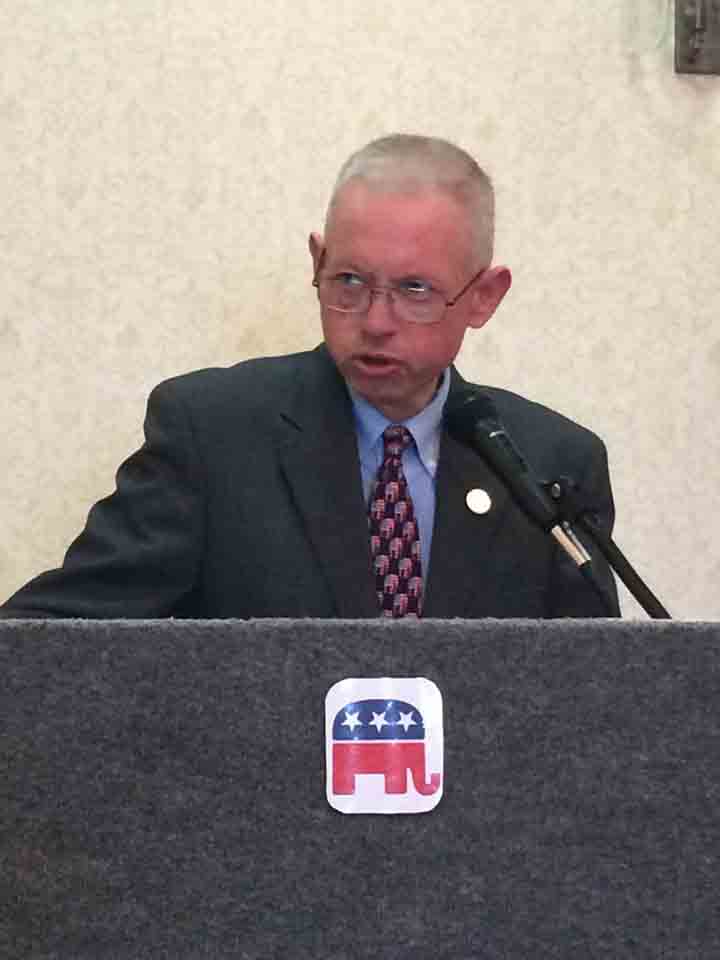 Shoemaker speaking at a podium